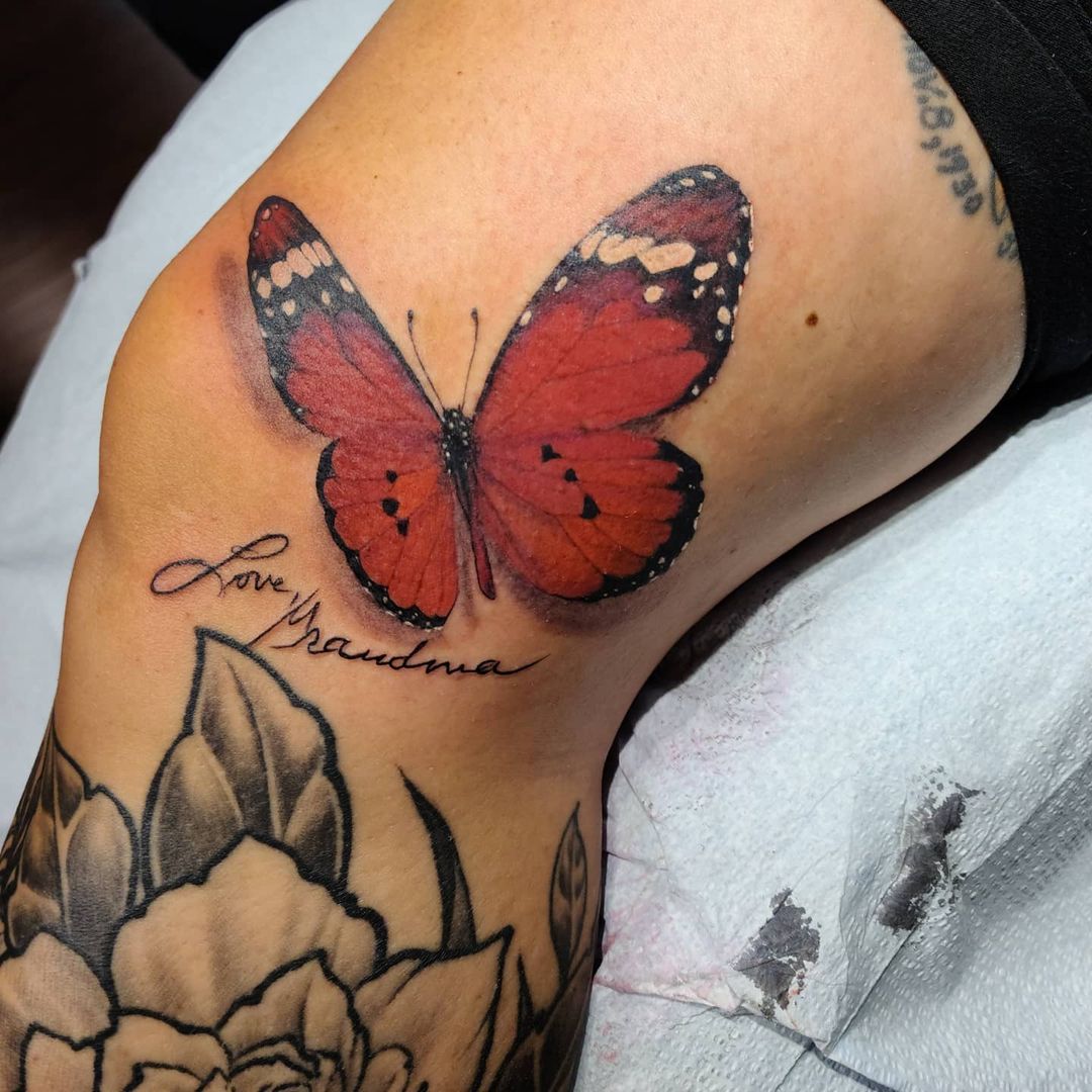 Red Butterfly Tattoo on thigh